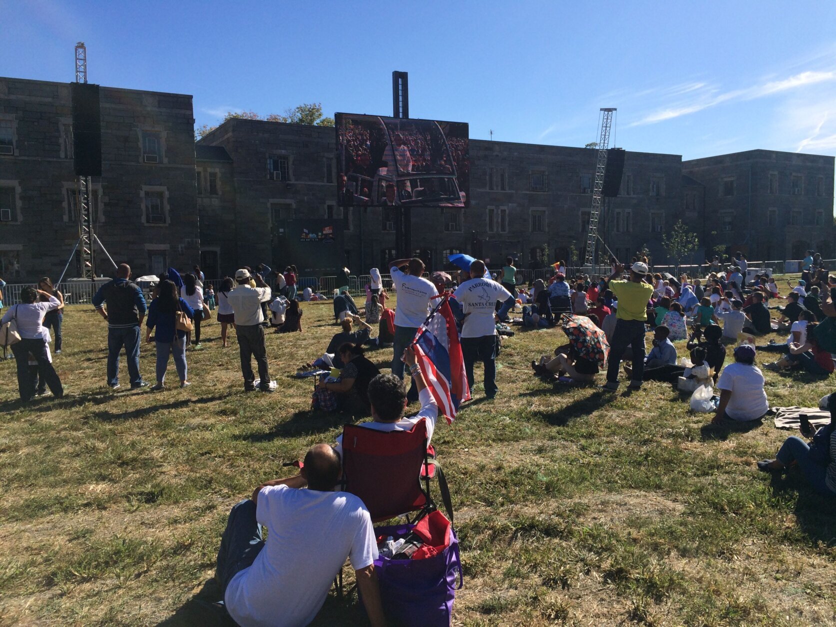 group of onlookers watch a screen